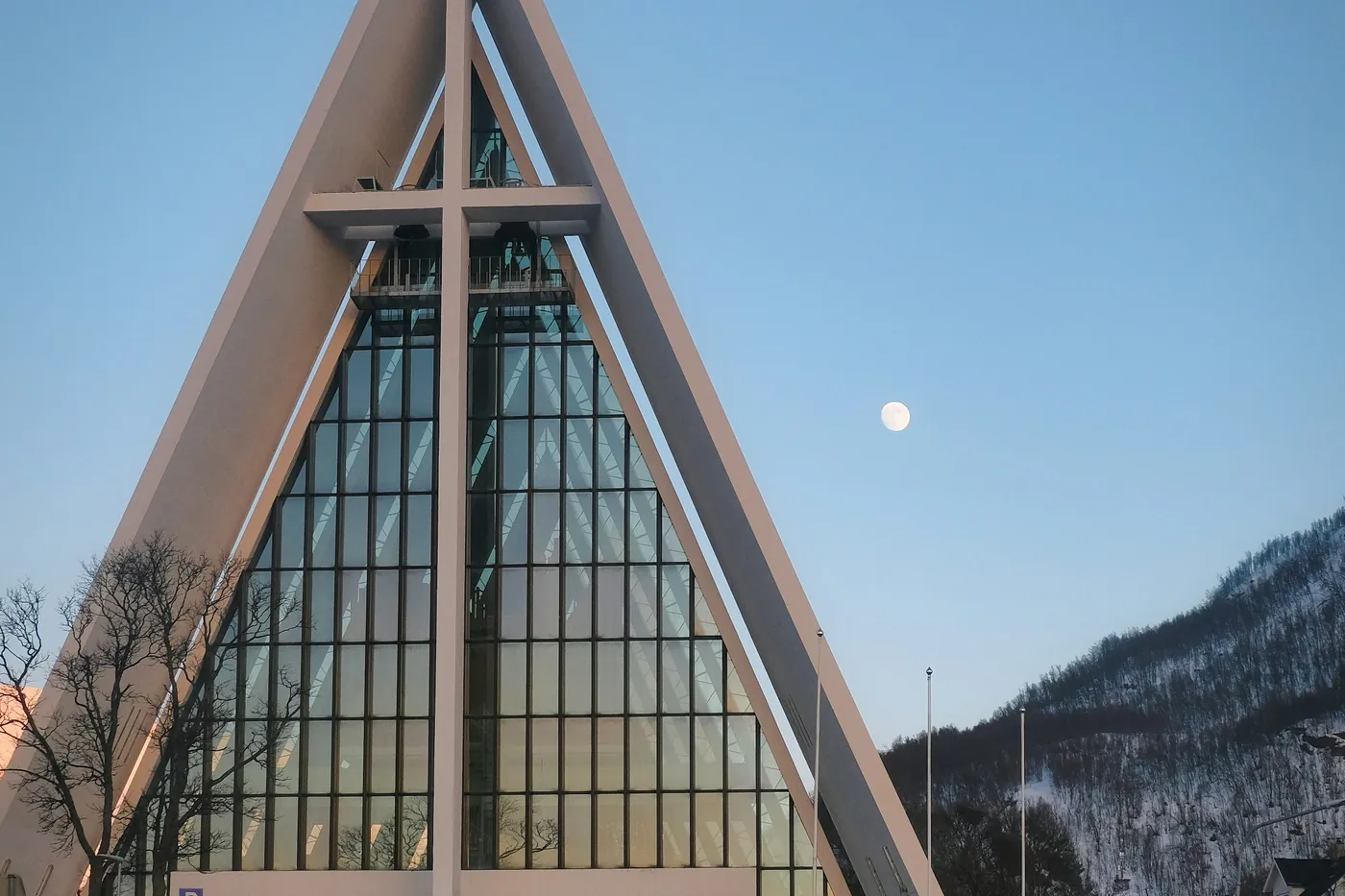 The Arctic Cathedral in daylight with the moon in the sky