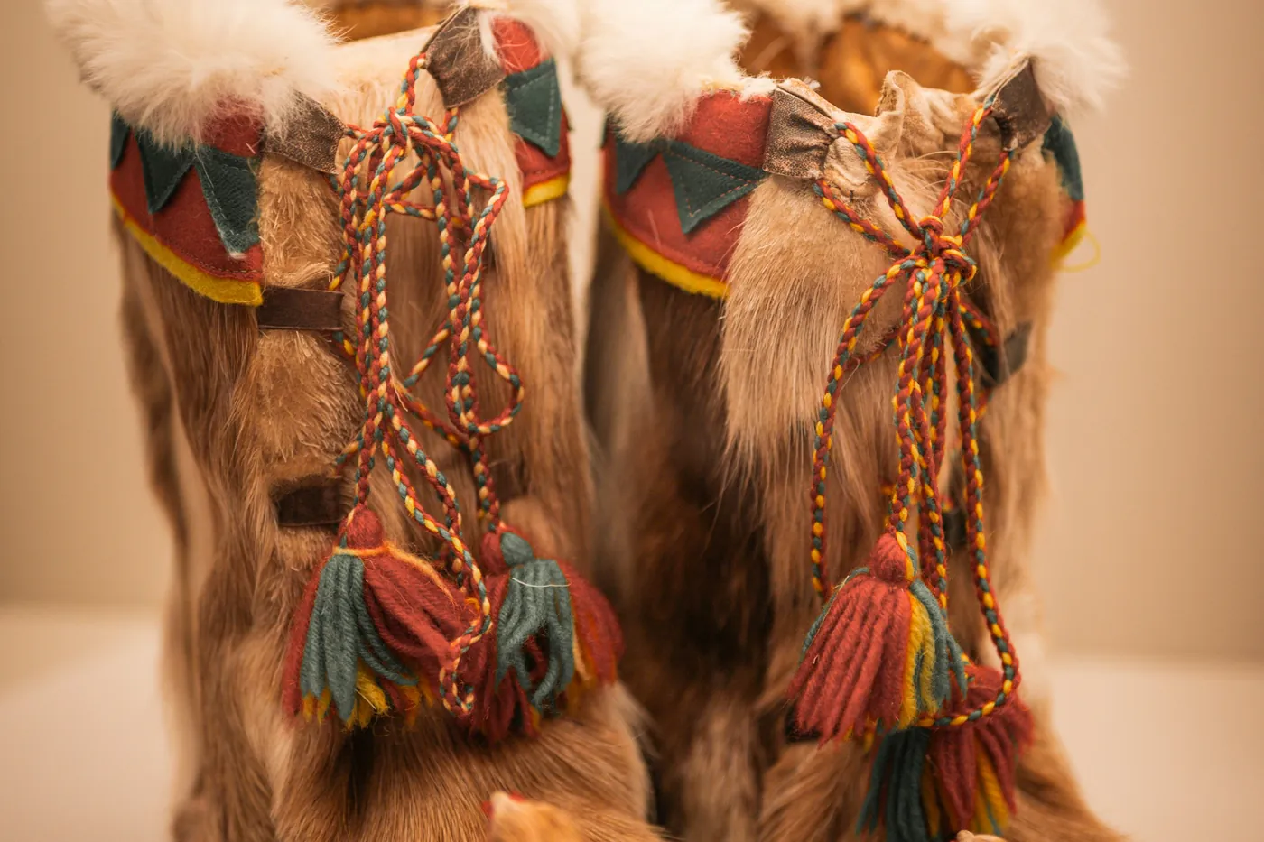 Fur boots tied with colourful woollen bands