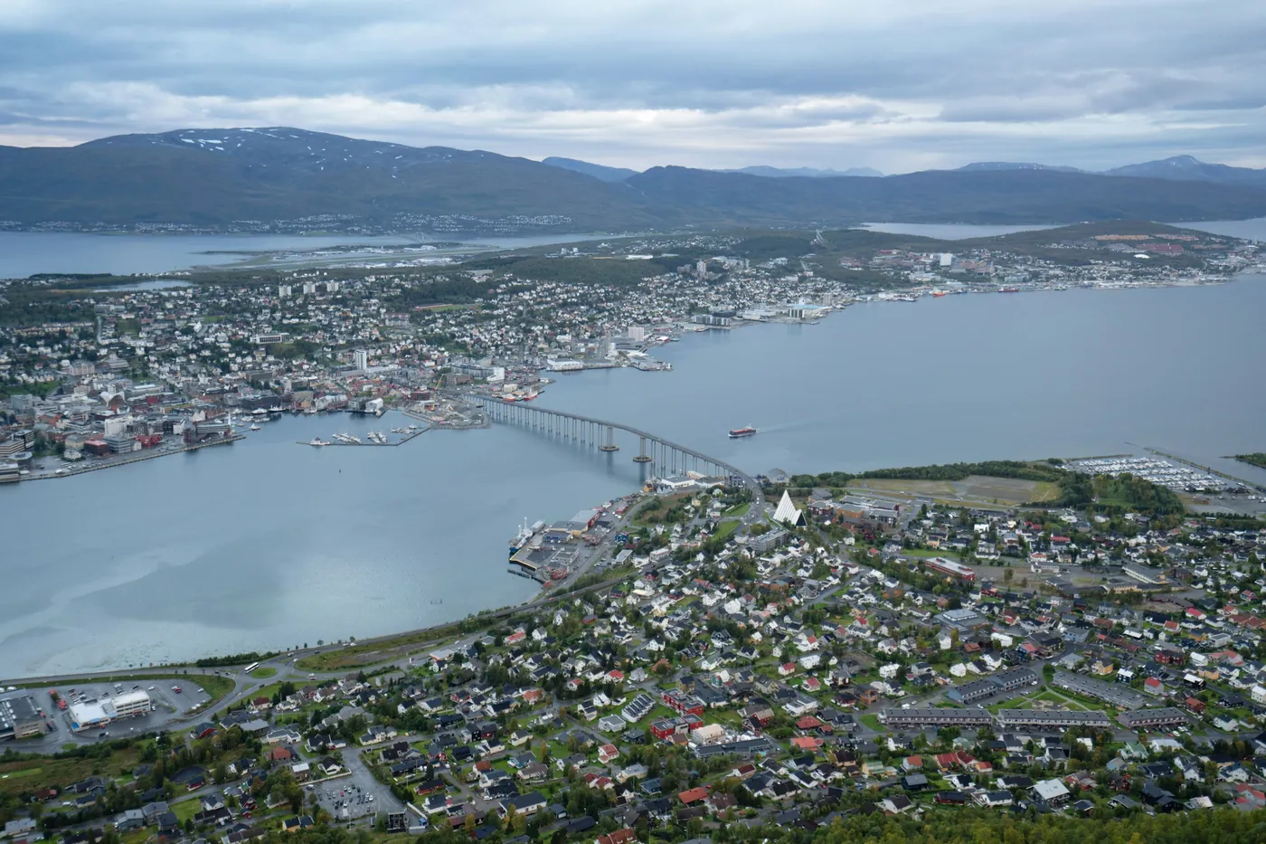 Tromsø and its bridge seen from above under a cloudy sky