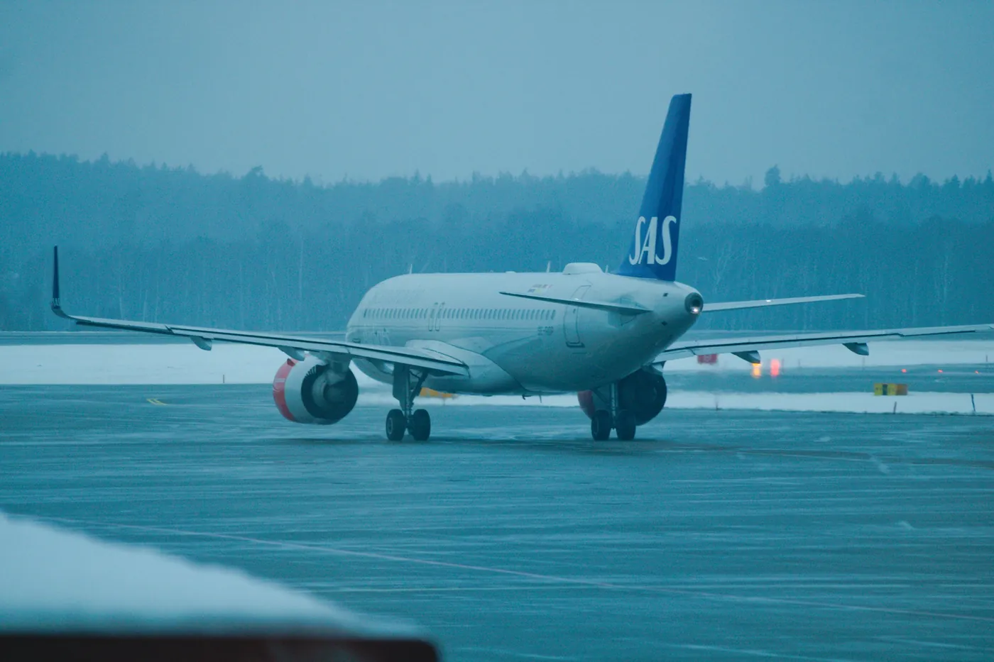 SAS aircraft standing on a runway covered in snow
