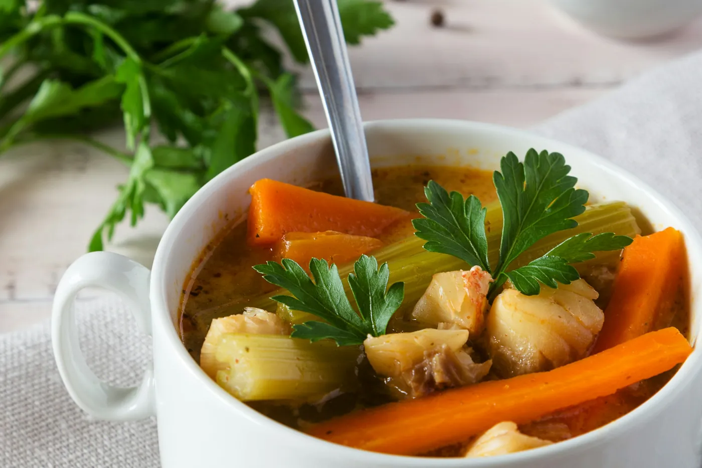 Bowl of fish soup with carrots